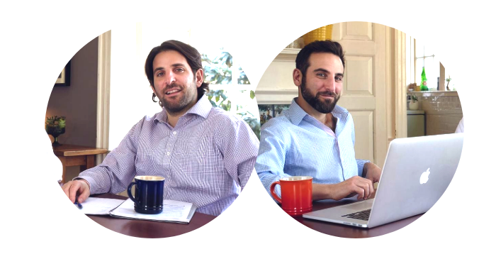 Two men sitting in front of laptops and paperwork