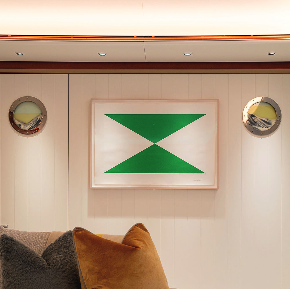 Art work on the wall with two green triangles sitting on top of each others' point