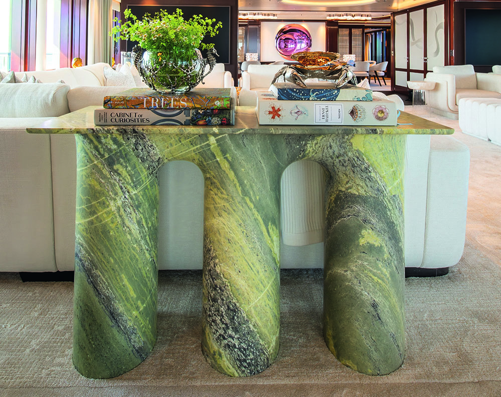 Abstract green table in marble effect with three chunky legs