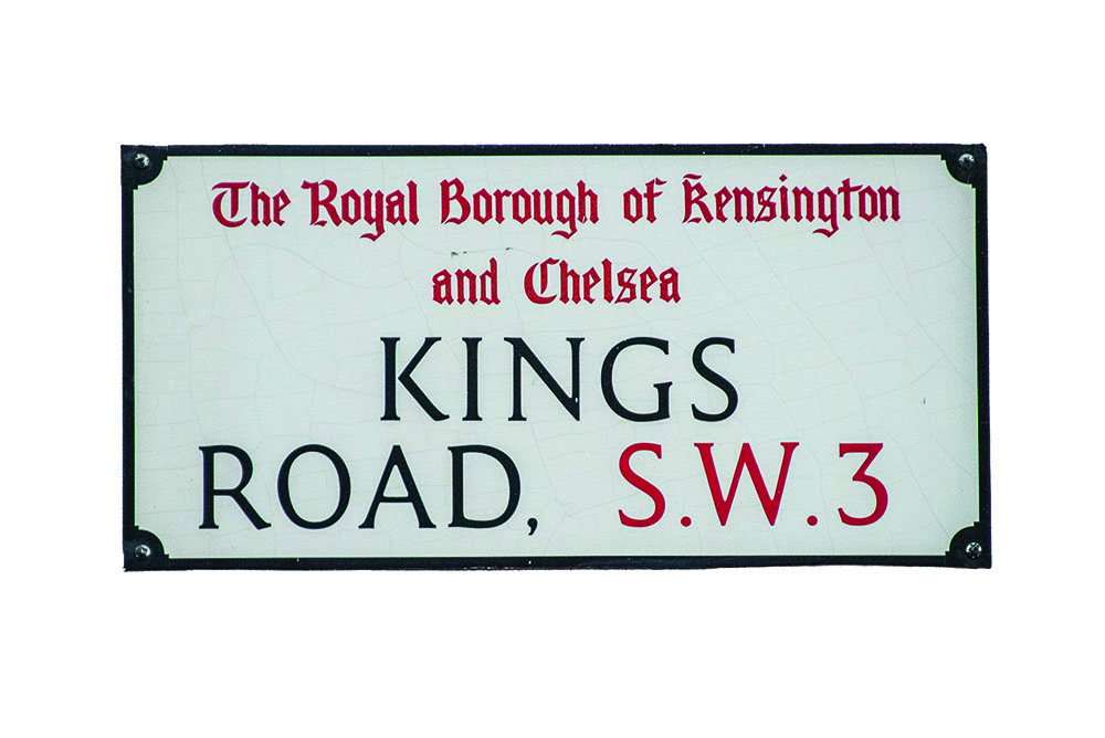 London street sign that reads King's Road in black and SW3 in red, undernearth the words "the Royal Borough of Kensington and Chelsea" in red
