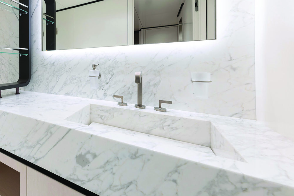 Close-up of a white marble sink with chrome taps