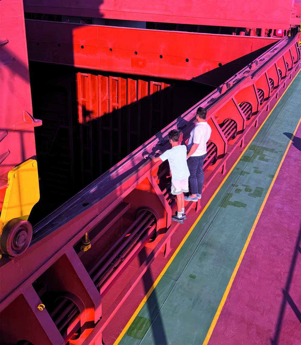 Two males looking at a boat